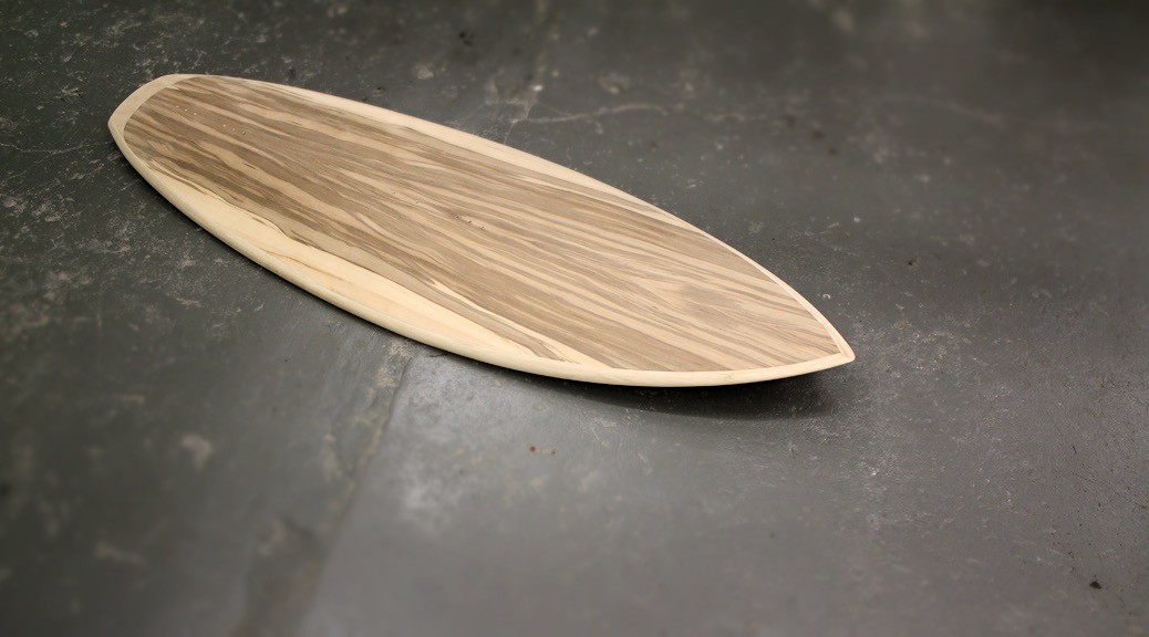 Wooden surfboard with veneer
